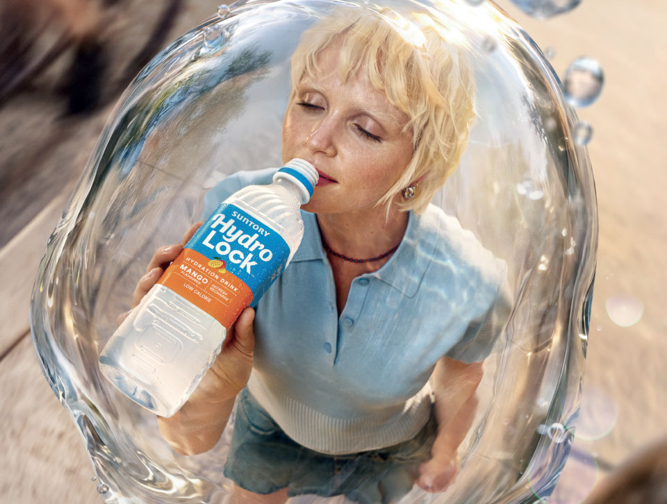 Woman drinking Suntory Hydro Lock inside a bubble